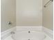 Corner bathtub with neutral-colored walls at 110 Phyllis Dr, Benson, NC 27504