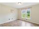Cozy bedroom with wood-look floors and natural light from the window at 110 Phyllis Dr, Benson, NC 27504