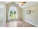 Bright bedroom with wood-look floors, vaulted ceiling, and large window at 110 Phyllis Dr, Benson, NC 27504