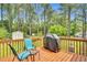 A wooden deck with outdoor seating and a grill at 110 Phyllis Dr, Benson, NC 27504