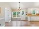 Open dining area with natural light, wood floors, and access to outdoor spaces at 110 Phyllis Dr, Benson, NC 27504