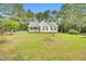 Charming one-story home featuring a landscaped lawn, white siding, and a cozy front porch at 110 Phyllis Dr, Benson, NC 27504