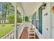 Inviting front porch with a cozy bench, decorative pillows, and charming curb appeal at 110 Phyllis Dr, Benson, NC 27504