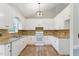 Well-appointed kitchen with white cabinets, granite countertops, and modern appliances at 110 Phyllis Dr, Benson, NC 27504