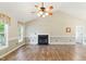 Spacious living room with vaulted ceilings, a fireplace, and beautiful hardwood floors at 110 Phyllis Dr, Benson, NC 27504