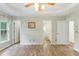 Primary bedroom with ensuite bathroom, windows, and wood-look floors at 110 Phyllis Dr, Benson, NC 27504