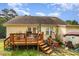 Inviting back deck is ideal for outdoor dining and overlooks a well-maintained yard with lush greenery at 1211 Azalea Dr, Zebulon, NC 27597