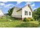 Backyard view features a fenced yard, beautiful landscaping, and lush green space, ensuring privacy and security at 1211 Azalea Dr, Zebulon, NC 27597