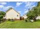 Backyard view includes a deck, grassy lawn, and mature trees, perfect for outdoor enjoyment and activities at 1211 Azalea Dr, Zebulon, NC 27597