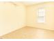 Empty bedroom featuring tile flooring and a window for natural light at 1211 Azalea Dr, Zebulon, NC 27597