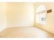 Bright bedroom featuring a large arched window, neutral colors, and tile flooring for a clean, modern look at 1211 Azalea Dr, Zebulon, NC 27597