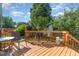 This beautiful wooden deck features an outdoor grill, seating area, and lush landscaping at 1211 Azalea Dr, Zebulon, NC 27597