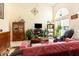 Cozy living room with large arched window, comfortable seating, and ample natural light at 1211 Azalea Dr, Zebulon, NC 27597