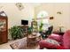Bright living room features a large arched window, comfortable seating, and stylish decor at 1211 Azalea Dr, Zebulon, NC 27597
