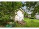 Backyard shed with access ramp in grassy area, surrounded by trees at 1211 Azalea Dr, Zebulon, NC 27597