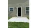 Backyard featuring a gray exterior wall and a small patio at 1249 Turkey Trot Rd, Wendell, NC 27591