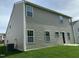 Backyard with green grass and a two-story home with light brown siding at 1249 Turkey Trot Rd, Wendell, NC 27591