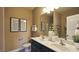 Well-lit bathroom with double vanity, framed mirrors, and neutral wall color at 1249 Turkey Trot Rd, Wendell, NC 27591