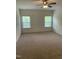 Bedroom features neutral carpet and two windows at 1249 Turkey Trot Rd, Wendell, NC 27591