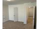 Bedroom featuring neutral carpet, a door, and is well-lit, offering a warm, comfortable setting at 1249 Turkey Trot Rd, Wendell, NC 27591