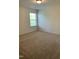 Bright bedroom with a window, neutral carpet, and simple decor, creating a welcoming space at 1249 Turkey Trot Rd, Wendell, NC 27591