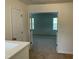Bright bedroom featuring neutral carpet, cream walls, and an open doorway to another room at 1249 Turkey Trot Rd, Wendell, NC 27591
