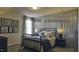Comfortable bedroom featuring a unique corrugated metal accent wall, soft lighting, and modern decor at 1249 Turkey Trot Rd, Wendell, NC 27591