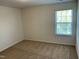 Comfortable bedroom with a bright window, neutral carpet, and a relaxing ambiance at 1249 Turkey Trot Rd, Wendell, NC 27591