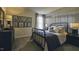Stylish bedroom with a metal accent wall, framed prints, neutral tones, and a cozy wrought iron bed frame at 1249 Turkey Trot Rd, Wendell, NC 27591