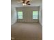 Bedroom features neutral carpet and two windows at 1249 Turkey Trot Rd, Wendell, NC 27591
