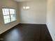 Bright dining room features dark hardwood floors and a modern chandelier fixture at 1249 Turkey Trot Rd, Wendell, NC 27591