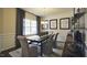 Bright dining area featuring modern light fixture, large window, and decorative accents on wall and furniture at 1249 Turkey Trot Rd, Wendell, NC 27591