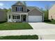 Beautiful two-story home with a two-car garage and inviting front porch nestled in a Gathering-friendly neighborhood at 1249 Turkey Trot Rd, Wendell, NC 27591