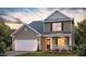 Charming two-story home with a covered front porch and attached two-car garage at 1249 Turkey Trot Rd, Wendell, NC 27591