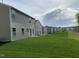 Exterior view of a row of two-story homes with light brown siding and green grass at 1249 Turkey Trot Rd, Wendell, NC 27591