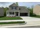 Charming two-story home featuring a covered porch, a spacious two-car garage, and a well-manicured lawn at 1249 Turkey Trot Rd, Wendell, NC 27591