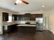 Modern kitchen with stainless steel appliances, granite countertops, dark wood cabinets and an island at 1249 Turkey Trot Rd, Wendell, NC 27591