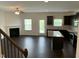 Open-concept living area with dark wood floors, fireplace, ceiling fan, and a view of the kitchen at 1249 Turkey Trot Rd, Wendell, NC 27591