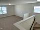 Loft with neutral carpet, stairs, and a large window at 1249 Turkey Trot Rd, Wendell, NC 27591