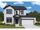 Charming two-story home with white siding, a black roof, and an attached two-car garage at 13 Cozy Hvn, Fuquay Varina, NC 27526
