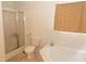 Bright bathroom featuring a soaking tub and glass-enclosed shower and a window with woven shade at 1333 Beaufort Dr, Graham, NC 27253