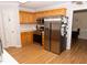 Well-lit kitchen with stainless steel appliances, wood cabinets, and a modern refrigerator at 1333 Beaufort Dr, Graham, NC 27253