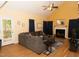 A spacious living room with hardwood floors, a fireplace, and a comfortable sectional sofa at 1333 Beaufort Dr, Graham, NC 27253
