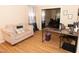 Inviting living room with wood floors, a cozy couch, and adjacent dining space at 1333 Beaufort Dr, Graham, NC 27253