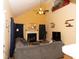 Cozy living room features a fireplace, ceiling fan and comfortable gray sofa at 1333 Beaufort Dr, Graham, NC 27253