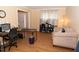 Open-concept living room offers wood floors, desk and a comfortable seating area at 1333 Beaufort Dr, Graham, NC 27253
