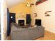Cozy living room featuring a fireplace, vaulted ceilings and a comfortable sectional sofa at 1333 Beaufort Dr, Graham, NC 27253