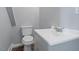 Bathroom featuring a white toilet, gray vanity, and luxury vinyl plank flooring at 134 Nelson St, Durham, NC 27707