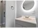 This bathroom offers a gray vanity, custom mirror, and modern fixtures at 134 Nelson St, Durham, NC 27707