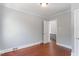 This bedroom features neutral paint, white trim, and hardwood floors at 134 Nelson St, Durham, NC 27707